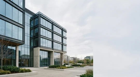 Modern commercial office building exterior with clean architecture representing pension property investment concept